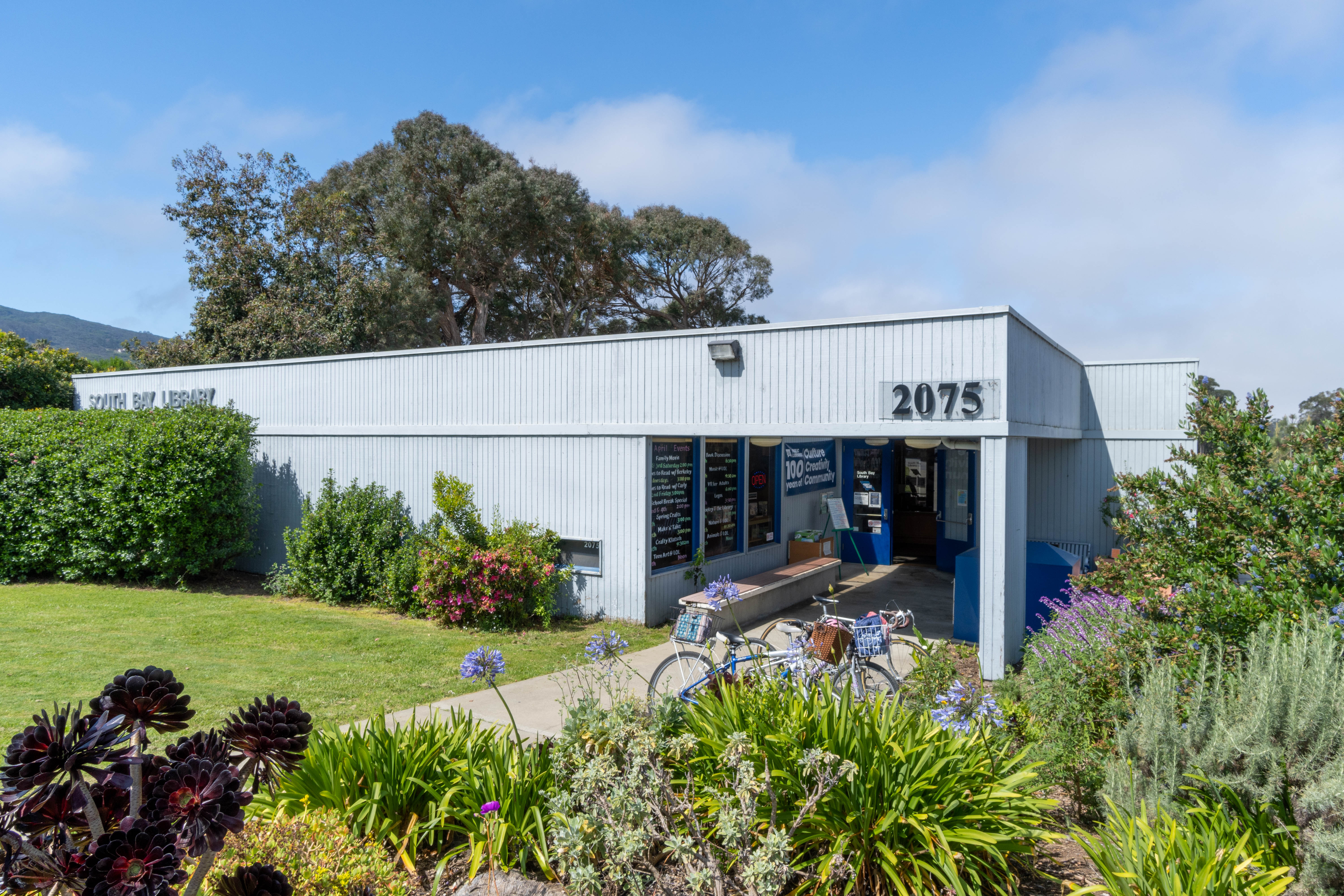 County of San Luis Obispo Public Libraries Los Osos, California, location. Blue building exterior with native gardens.