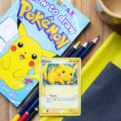How to Draw Pokemon book, Pokemon playing card, and colored pencils