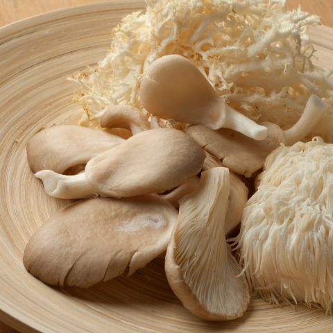 lion's mane mushroom, shitake mushrooms on wood tray
