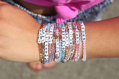 Bracelet made of multi-colored beads and beads printed with letters.