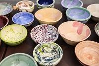 Rows of ceramic bowls painted with different colors