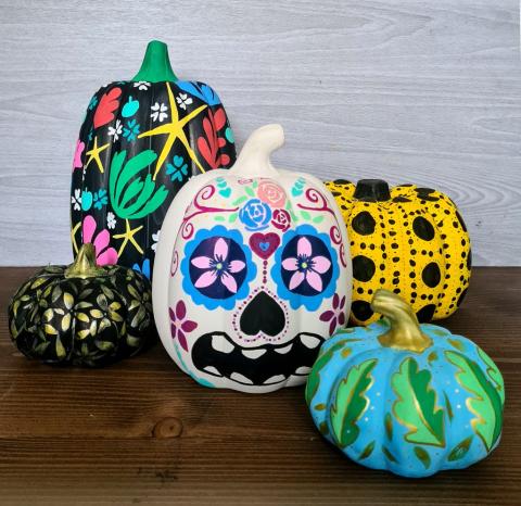 Pumpkins painted with fall colors and designs