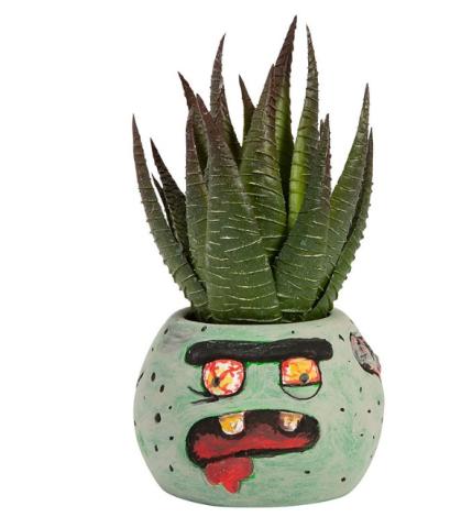 small planter with a silly zombie face and faux plant inside