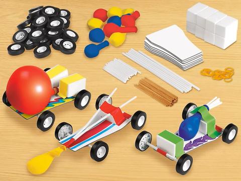 Photo of wheels, balloons, foam, straws, cardboard, and rubber bands to make a car model.