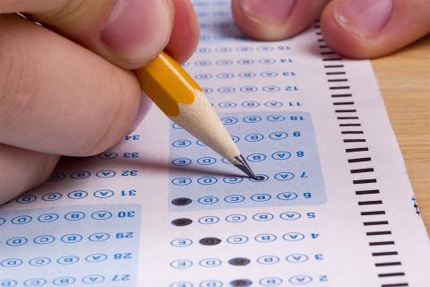 hand and pencil marking SAT test
