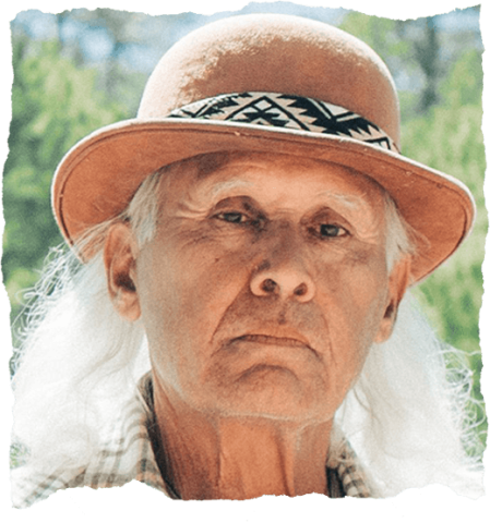 Close-up photo of a Native man with flowing white hair 