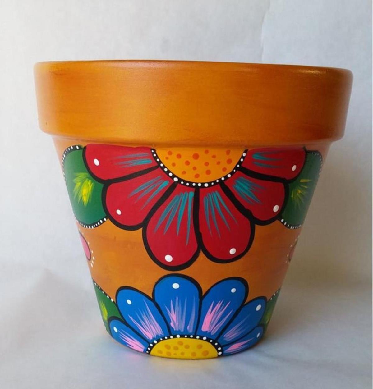 Flower pot decorated with a painted floral design.