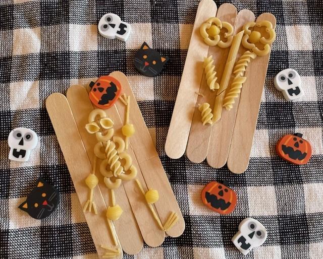 Photo of craft skeletons made out of pasta.