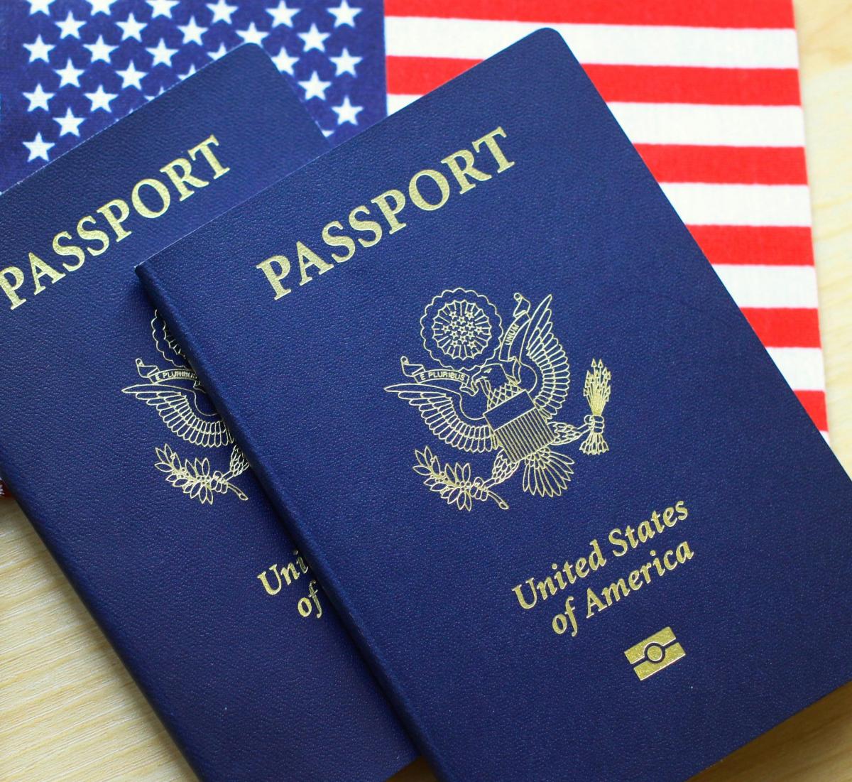 two American passports on top of an American flag